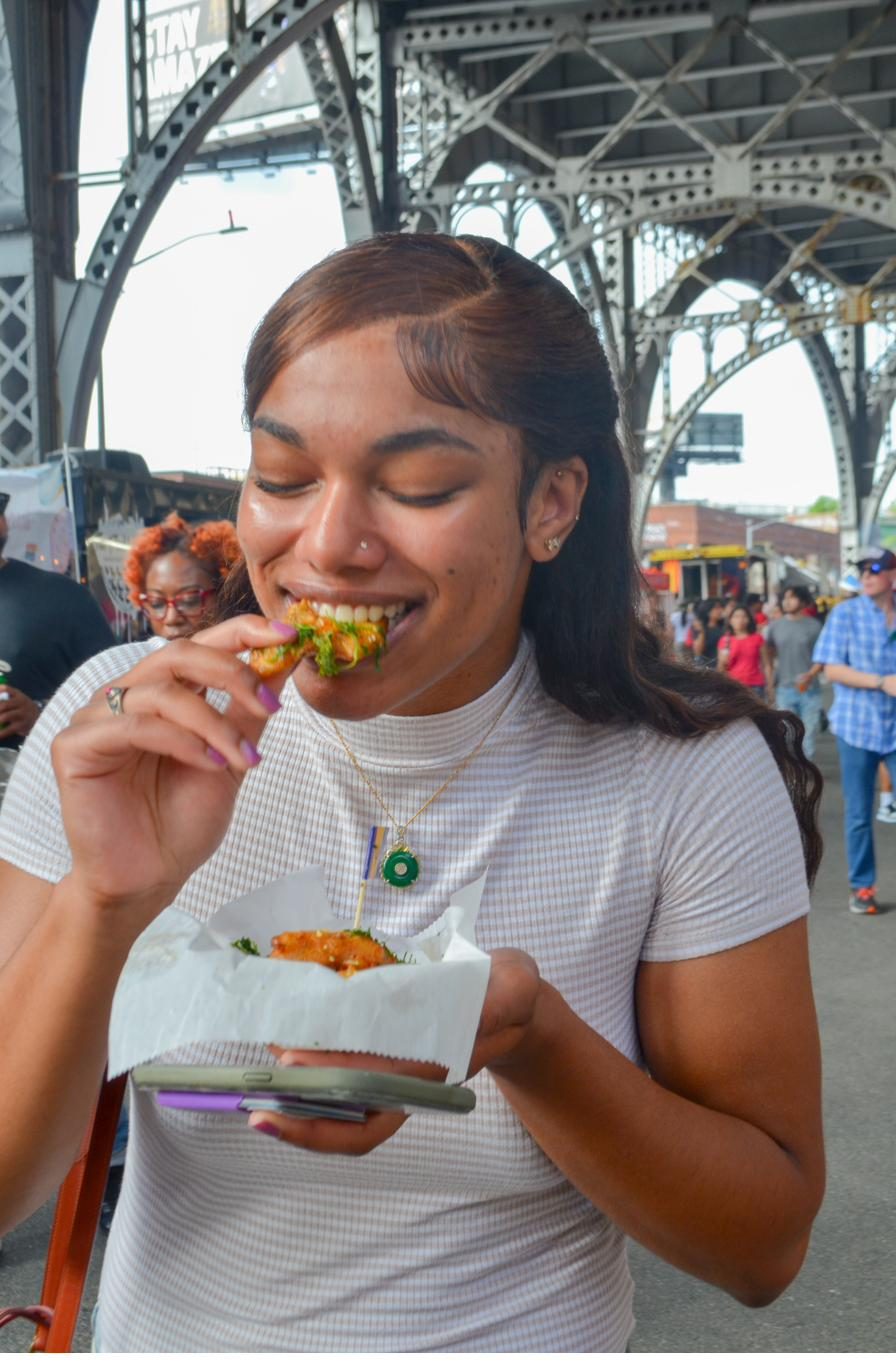 Guest eating at Harlem Summer Nights