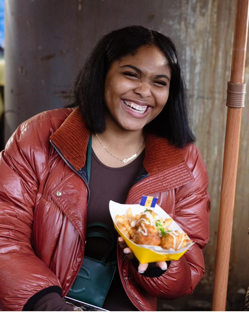 Guest laughing with a plate at the market