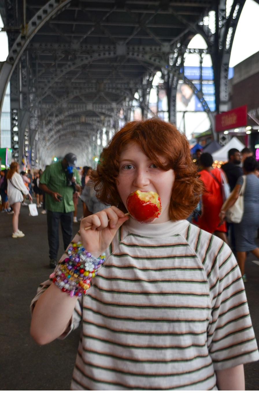 Guest with a candy apple under the lights